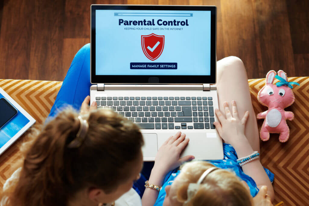 mother and daughter on laptop with parental controls